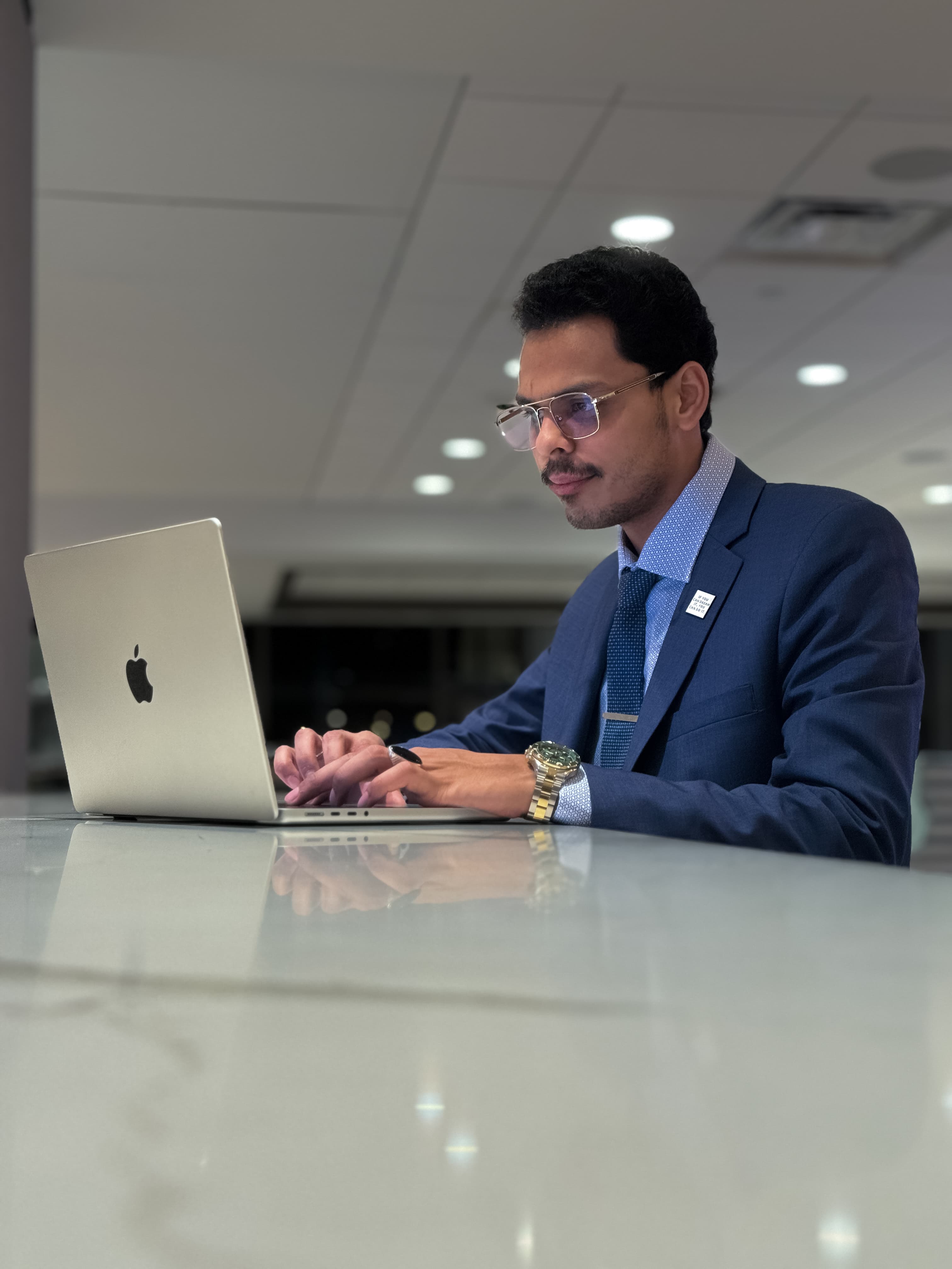 Syed Ali Adnan working at a hotel front desk